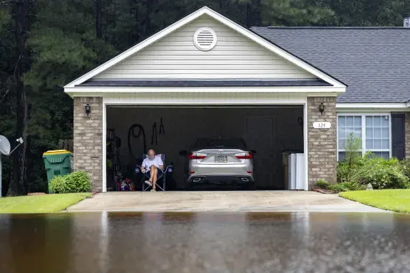 Storm runoff flooding a driveway and pouring into an attached garage in Sammamish, WA